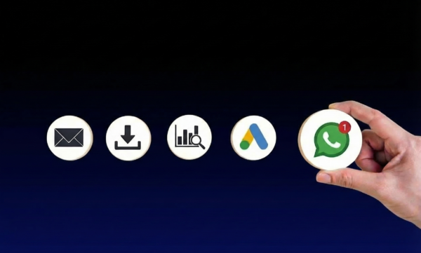 A hand holding a circular wooden icon featuring the WhatsApp marketing and other digital marketing services offered including Google ads, lead generation campaigns, and email marketing.
